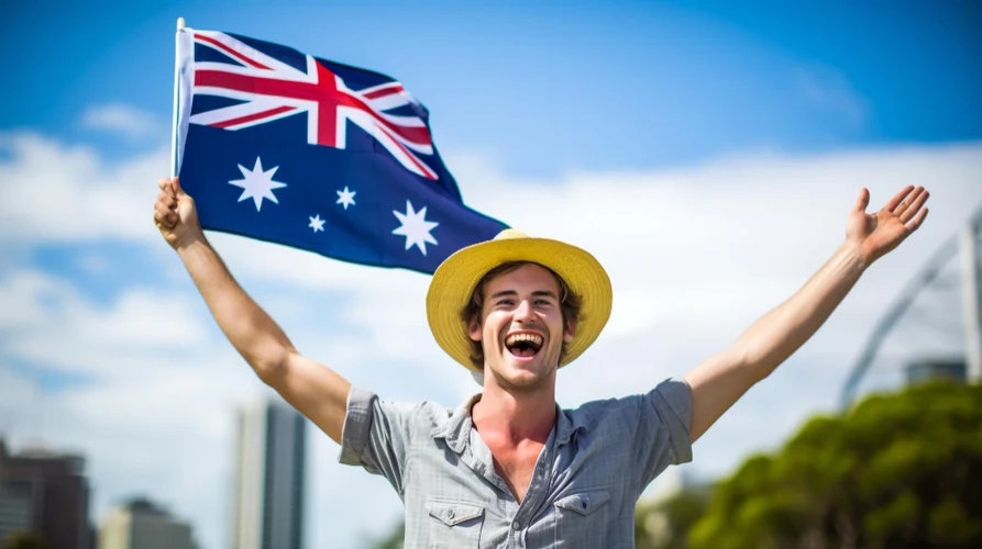 A young man holding Australian Flag - How to get PR in Australia