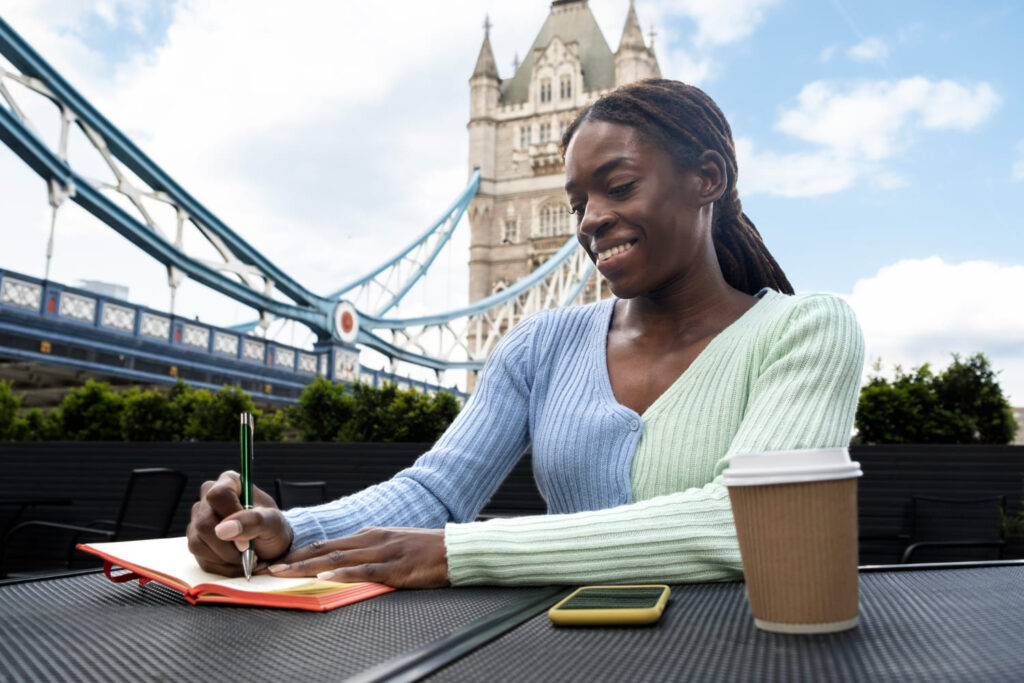 A student studying in the UK with the iconic Tower Bridge in the background, symbolizing global education opportunities in the UK. Ideal for international students seeking to advance their studies abroad