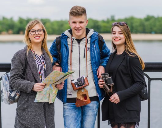 Three foreign students discussing about Affordable Study Abroad Programs in Ireland